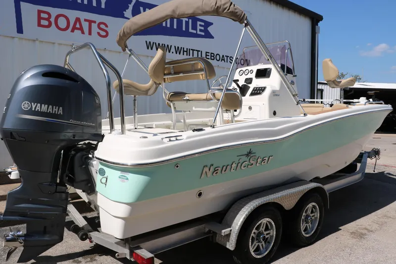 Slide: The Image of 2020 NauticStar 211 Hybrid boat on trailer with Yamaha outboard motor. - 3