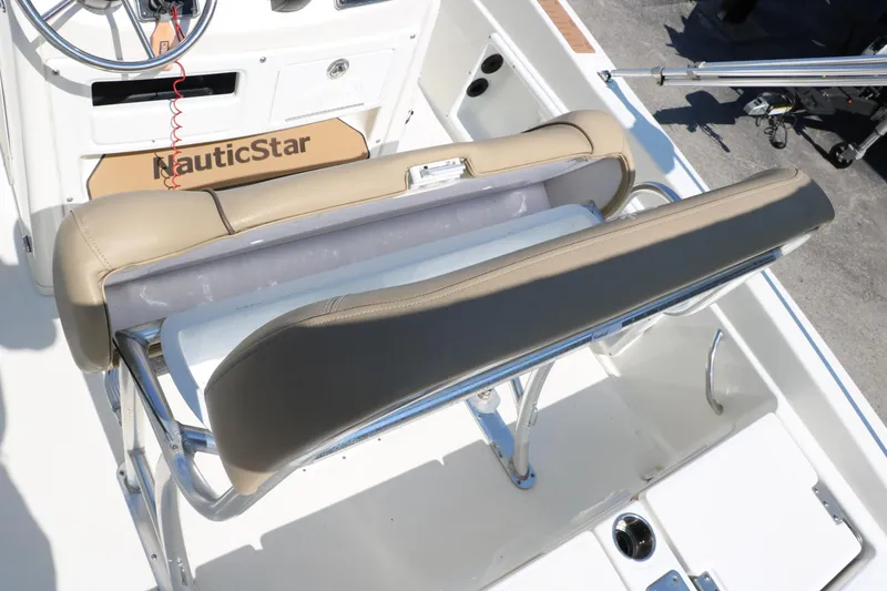 Slide: The Image of 2020 NauticStar 211 Hybrid boat interior with tan seating and steering console. - 34