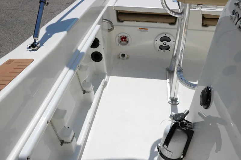 Slide: The Image of 2020 NauticStar 211 Hybrid boat interior with rod holders and clean white deck. - 38