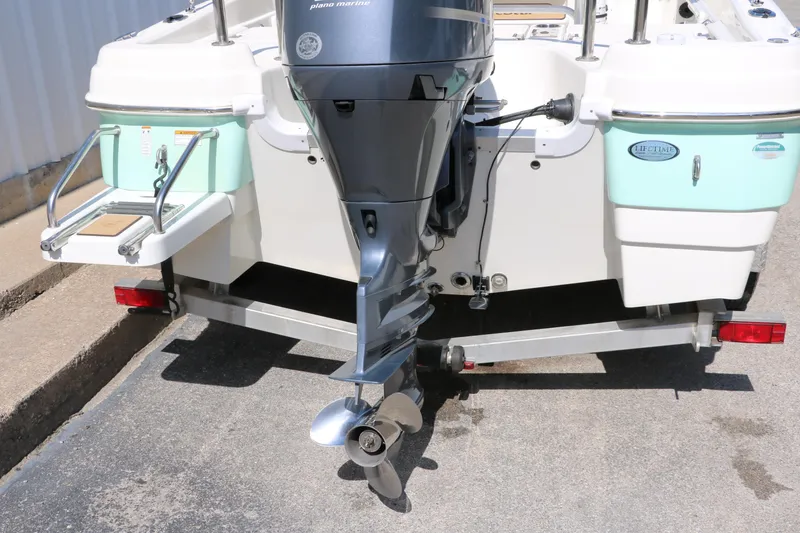 Slide: The Image of 2020 NauticStar 211 Hybrid boat with outboard motor on trailer. - 5