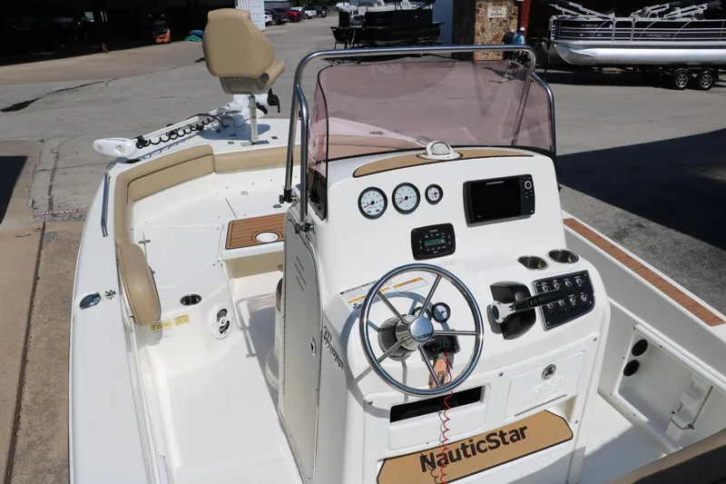 Slide: The Image of 2020 NauticStar 211 Hybrid boat on trailer, mint green and white hull, outdoor setting. - 8