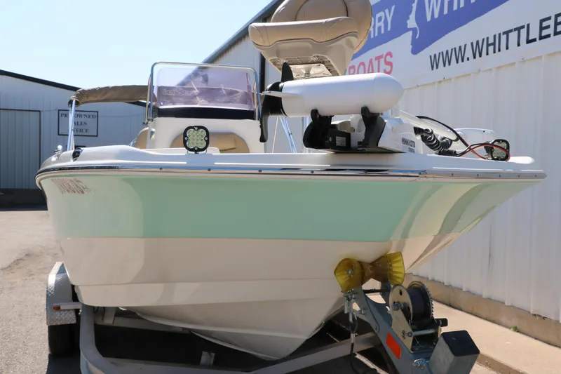 Slide: The Image of 2020 NauticStar 211 Hybrid boat on trailer, displayed outdoors. - 9