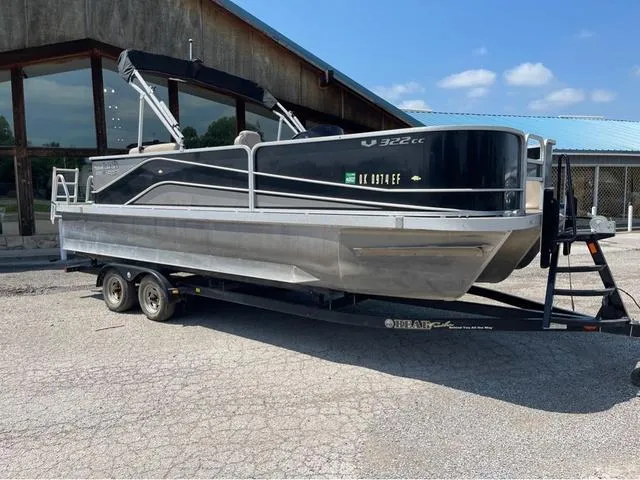 Slide: The Image of 2019 SunCatcher V 322CC pontoon boat on trailer, parked outdoors. - 1