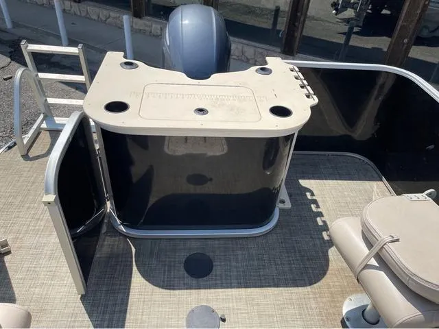Slide: The Image of 2019 SunCatcher V 322CC boat deck with seating and storage area. - 10