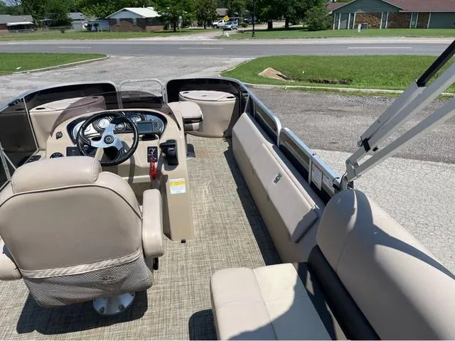 Slide: The Image of 2019 SunCatcher V 322CC boat interior with beige seating and steering console. - 12