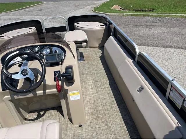 Slide: The Image of 2019 SunCatcher V 322CC boat interior with steering console and seating. - 14