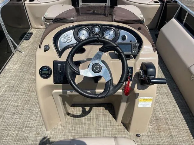 Slide: The Image of 2019 SunCatcher V 322CC boat dashboard with steering wheel and control panel. - 15