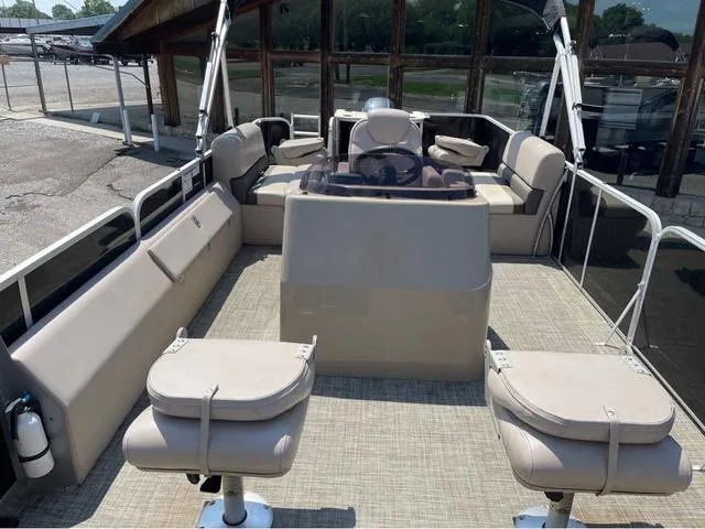 Slide: The Image of 2019 SunCatcher V 322CC pontoon boat interior with beige seating and steering console. - 6