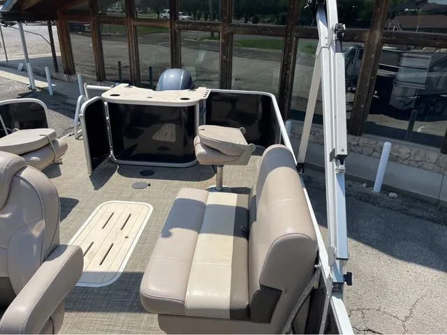 Slide: The Image of 2019 SunCatcher V 322CC pontoon boat interior with beige seating and helm. - 7