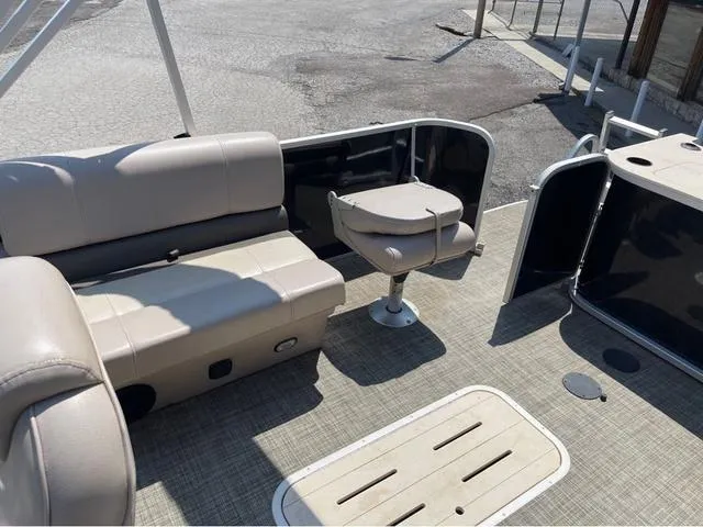 Slide: The Image of 2019 SunCatcher V 322CC pontoon boat interior with beige seating and open deck. - 8