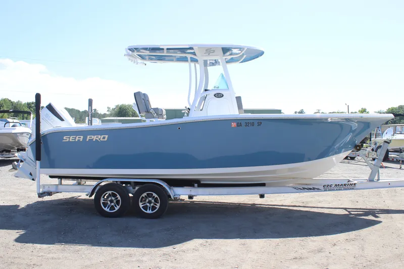 Slide: The Image of 2023 Sea Pro 239 Center Console boat on trailer, side view, blue hull. - 6