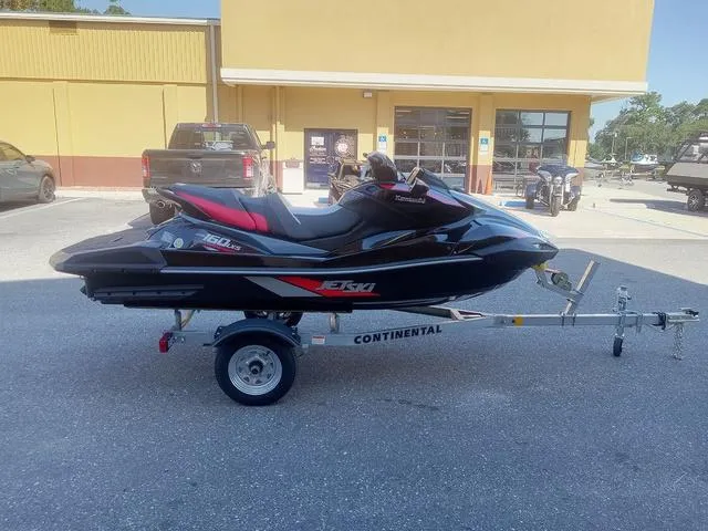 Slide: The Image of 2025 Kawasaki Waverunner Ultra 160LX-S on trailer, parked outside a building. - 1