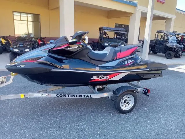 Slide: The Image of 2025 Kawasaki Waverunner Ultra 160LX-S on trailer, black and red design. - 11