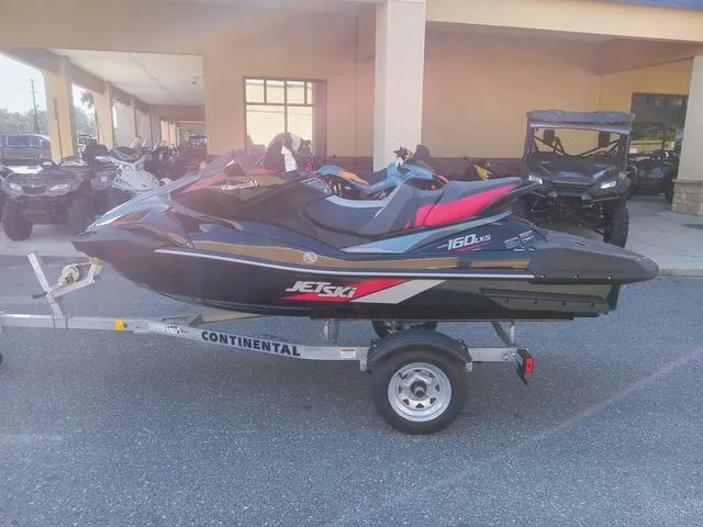 Slide: The Image of 2025 Kawasaki Waverunner Ultra 160LX-S on trailer, parked outside dealership. - 12