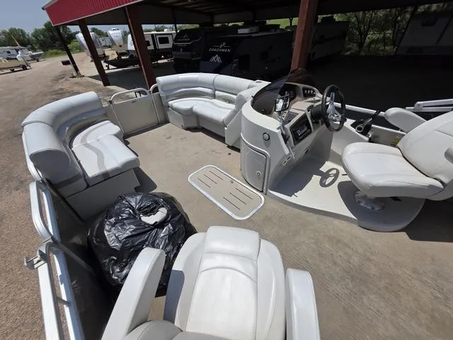 Slide: The Image of 2013 Bennington 2275GLW pontoon boat interior with white seating and canopy. - 10