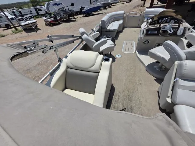 Slide: The Image of 2013 Bennington 2275GLW boat with beige seating and cup holder on deck. - 14