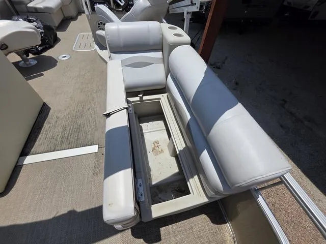 Slide: The Image of 2013 Bennington 2275GLW pontoon boat interior with white seating and steering console. - 16