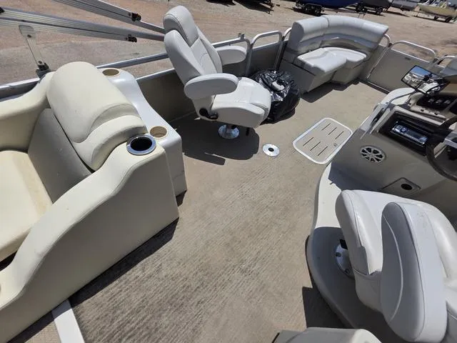 Slide: The Image of 2013 Bennington 2275GLW boat interior with open storage compartment under cushioned seating. - 17