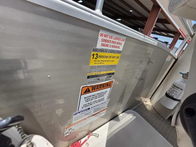 Slide: The Image of 2013 Bennington 2275GLW pontoon boat interior with plush seating and steering console. - 18