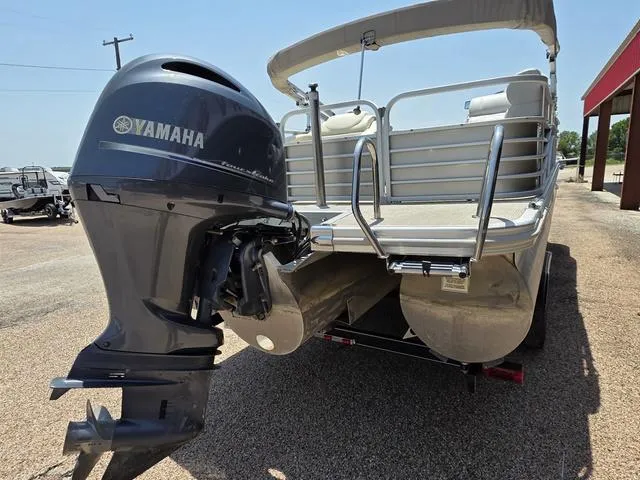 Slide: The Image of 2013 Bennington 2275GLW pontoon boat with Yamaha outboard motor, parked on a trailer. - 3