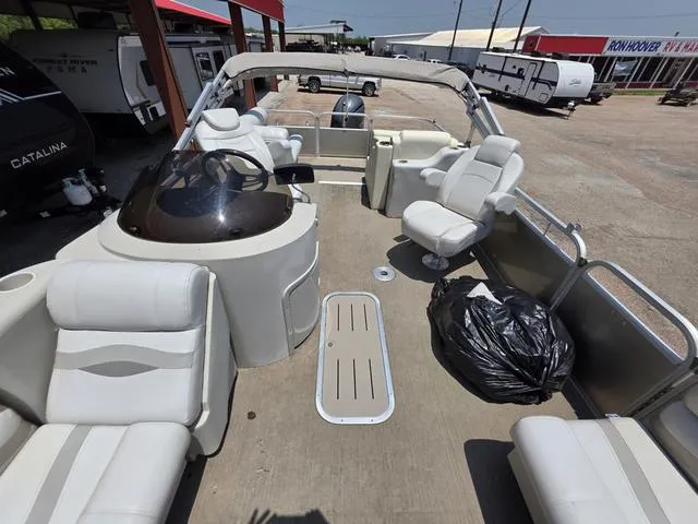 Slide: The Image of 2013 Bennington 2275GLW pontoon boat with spacious seating, parked at a dealership. - 7