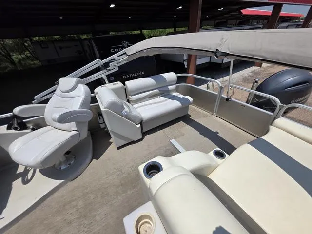 Slide: The Image of 2013 Bennington 2275GLW pontoon boat interior with white seating and canopy. - 9