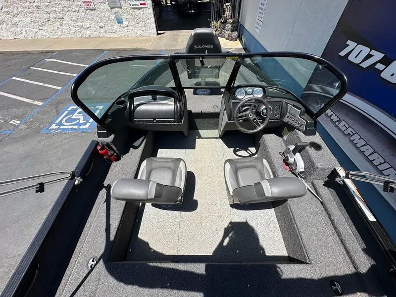 Slide: The Image of 2022 Lund 1650 Rebel XL Sport boat interior with dual seats and steering console. - 13