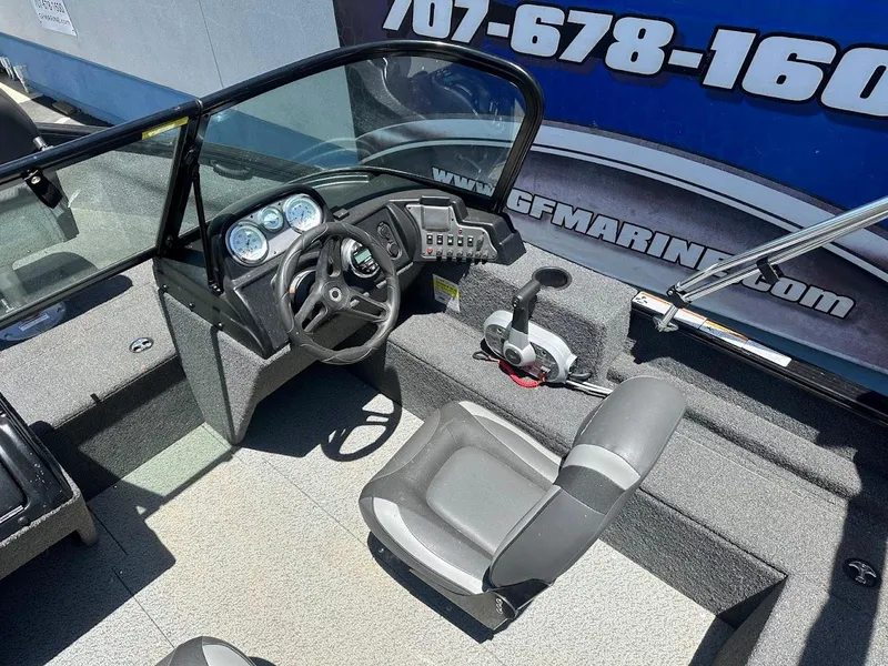 Slide: The Image of 2022 Lund 1650 Rebel XL Sport boat interior with steering console and seating. - 15