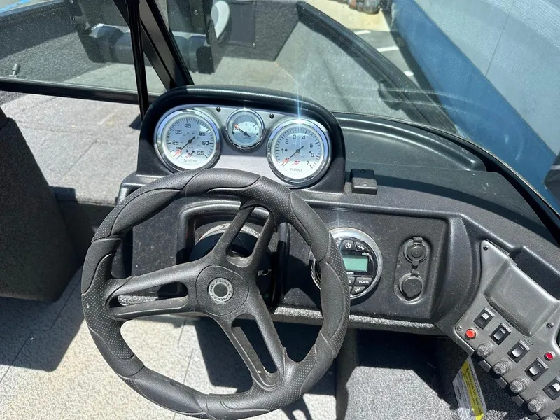 Slide: The Image of 2022 Lund 1650 Rebel XL Sport dashboard with steering wheel and gauges. - 17