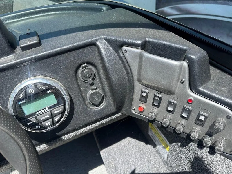 Slide: The Image of Control panel of 2022 Lund 1650 Rebel XL Sport boat with switches and audio system. - 18