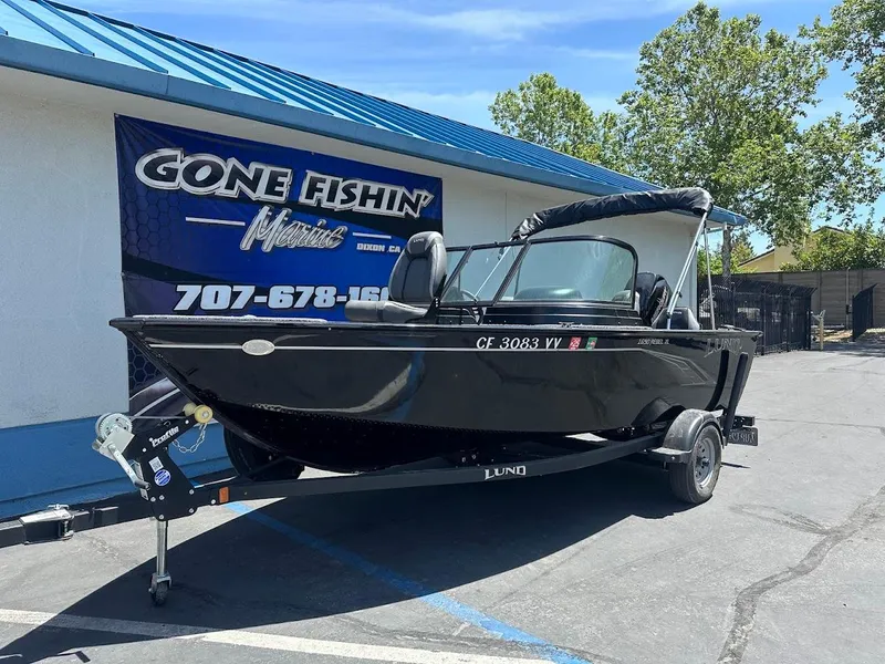 Slide: The Image of 2022 Lund 1650 Rebel XL Sport boat on trailer outside dealership. - 2