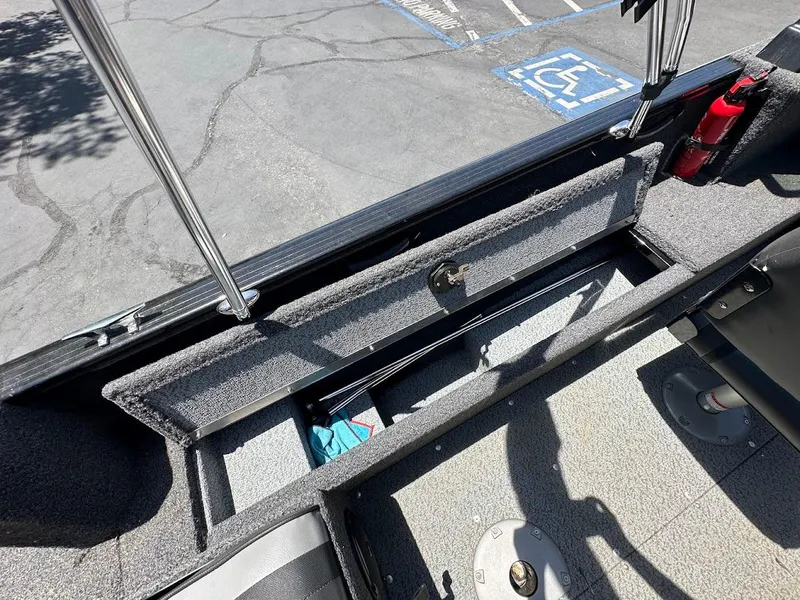 Slide: The Image of 2022 Lund 1650 Rebel XL Sport boat interior storage compartment, open and empty. - 22