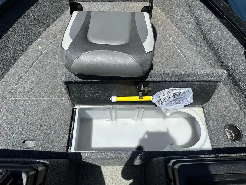 Slide: The Image of 2022 Lund 1650 Rebel XL Sport boat interior with seat and storage compartment. - 25