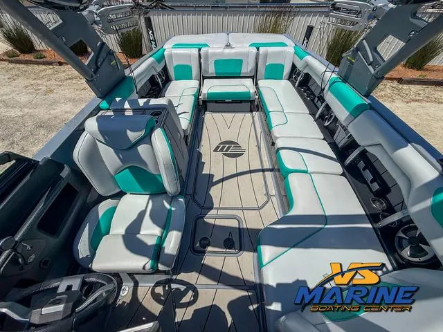 Slide: The Image of 2020 Malibu 25 LSV boat interior with teal and gray seating at VS Marine Boating Center. - 5