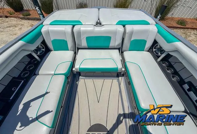 Slide: The Image of 2020 Malibu 25 LSV boat interior with teal and white seating, VS Marine logo. - 6