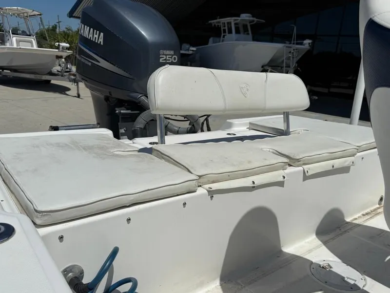 Slide: The Image of 2007 Century 2202 BAY boat on trailer, parked outside a building with American flag. - 2