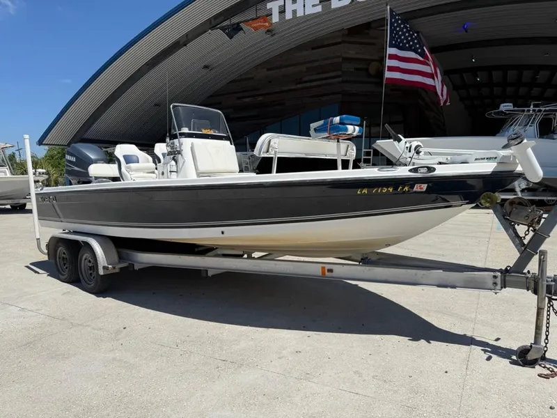 Slide: The Image of 2007 Century 2202 BAY boat on trailer, parked outside with American flag. - 3