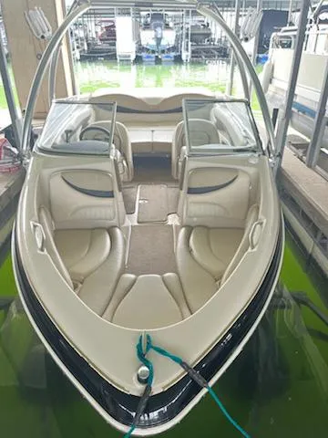 Slide: The Image of 2004 Glastron GS 205 boat with beige interior docked in a marina. - 1