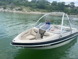 Slide: The Image of 2004 Glastron GS 205 boat on a lake with a driver. - 2