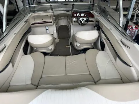 Slide: The Image of 2004 Glastron GS 205 boat interior with beige seating and steering wheel. - 8