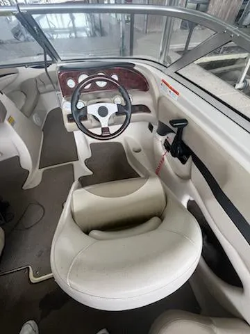 Slide: The Image of 2004 Glastron GS 205 boat interior with steering wheel and seating. - 9