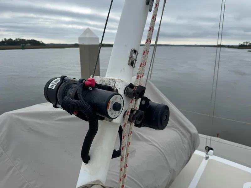 Slide: The Image of 2003 Nordhavn N46 sailboat mast detail with rigging and equipment, overcast sky in background. - 11