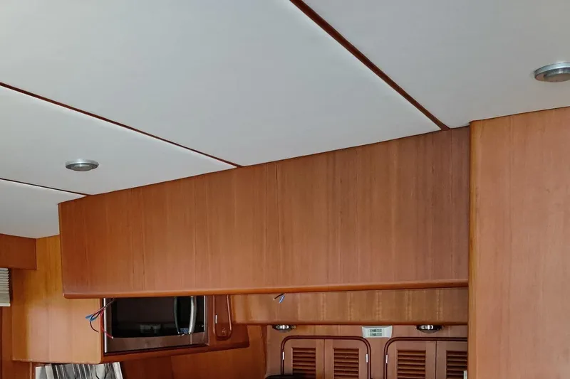 Slide: The Image of Interior of 2003 Nordhavn N46 yacht with wooden cabinetry and modern lighting. - 15
