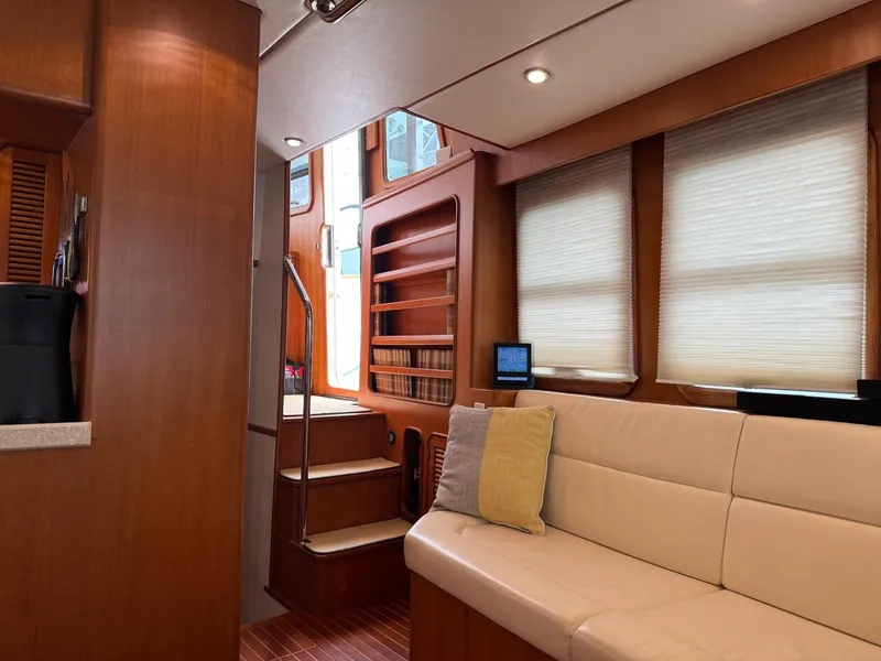 Slide: The Image of Interior of 2003 Nordhavn N46 yacht with cozy seating and wooden accents. - 18