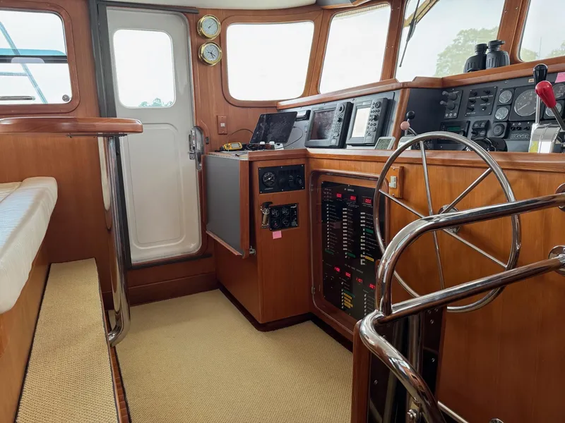 Slide: The Image of Pilothouse of 2003 Nordhavn N46 yacht with steering wheel and navigation instruments. - 19