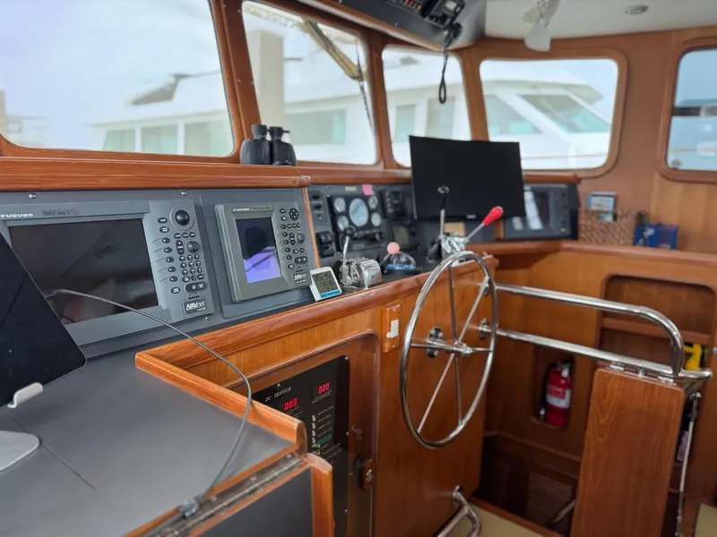 Slide: The Image of 2003 Nordhavn N46 yacht helm with navigation equipment and wooden interior. - 20