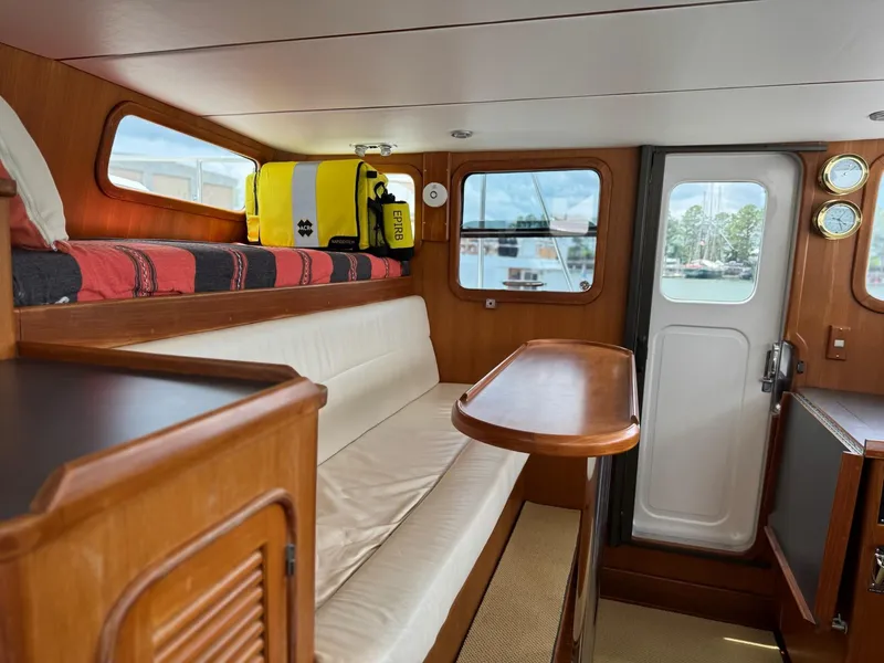 Slide: The Image of Interior of 2003 Nordhavn N46 yacht with seating, table, and windows. - 21