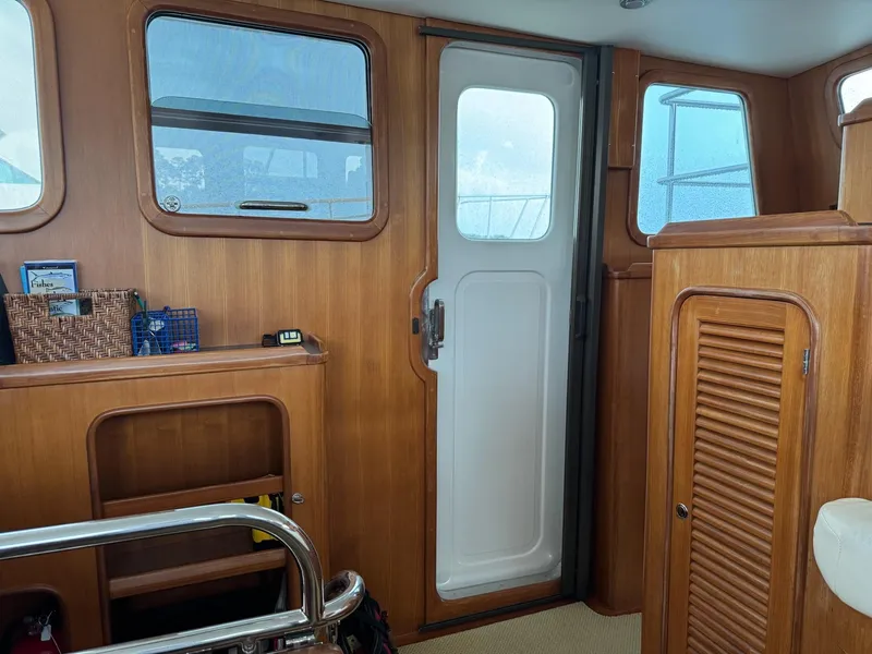 Slide: The Image of Interior of 2003 Nordhavn N46 yacht with wooden paneling and door. - 22