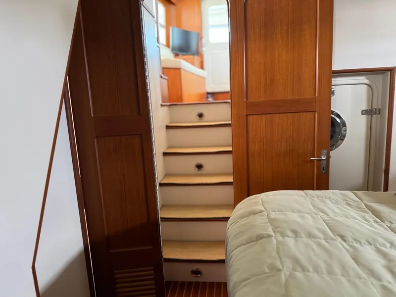 Slide: The Image of Interior of 2003 Nordhavn N46 yacht with wooden stairs and cozy cabin. - 23