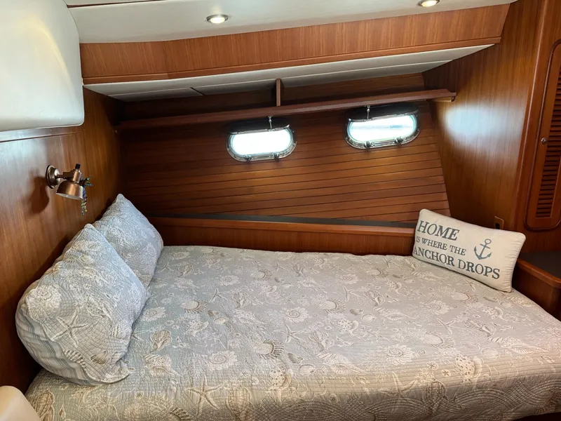 Slide: The Image of Cozy cabin interior of 2003 Nordhavn N46 yacht with nautical decor and bedding. - 28